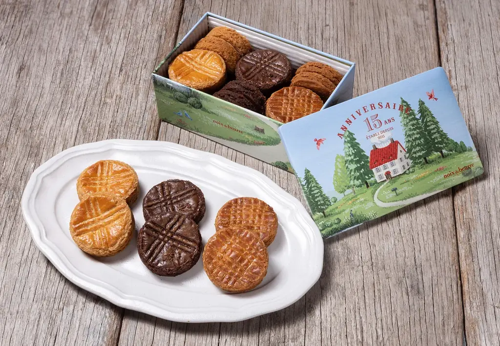 焼きたてフィナンシェが代表商品の〈ノワ・ドゥ・ブール〉は15周年アニバーサリー企画「サブレ・アソルティ(アニヴェルセル)S缶」を3月30日(月)より販売いたします。 画像 1